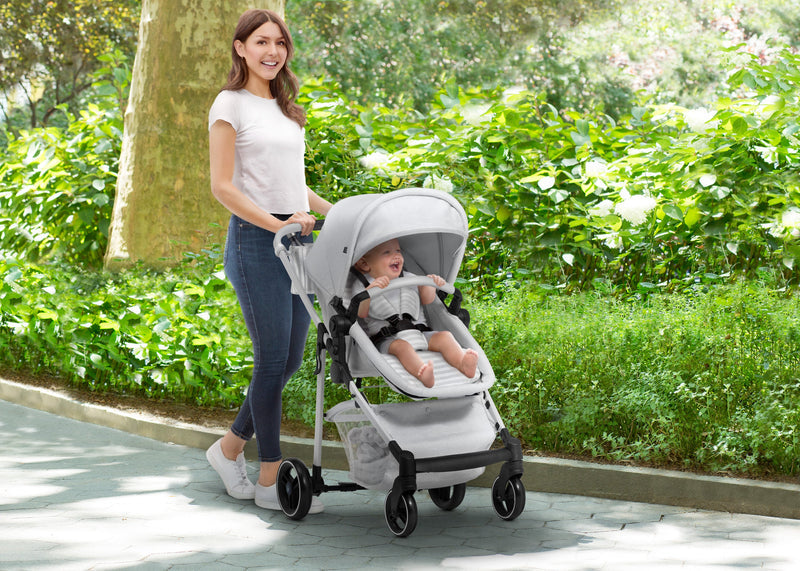 Woman pushing a baby in a stroller through a park 19-babyGap 2-in-1 Carriage Stroller