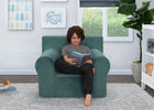 Child sitting in a green armchair reading a book in a room with a window and plant. 16-XL Cozee Foam Chair - Perfect Size for Kids Ages 18 Months - 12 Years+