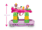 A pink and green baby walker with colorful toy attachments, shown on a white background with a pink measurement arrow and the text 'It Bounces!'. 18-Lil’ Play Station 4-in-1 Activity Walker