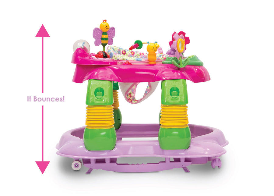 A pink and green baby walker with colorful toy attachments, shown on a white background with a pink measurement arrow and the text 'It Bounces!'. 18-Lil’ Play Station 4-in-1 Activity Walker