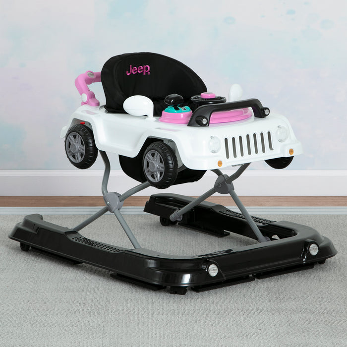A green Jeep Wrangler baby walker designed for toddlers, featuring a toy tray and interactive features. 0-Jeep® Classic Wrangler 3-in-1 Grow With Me Walker
