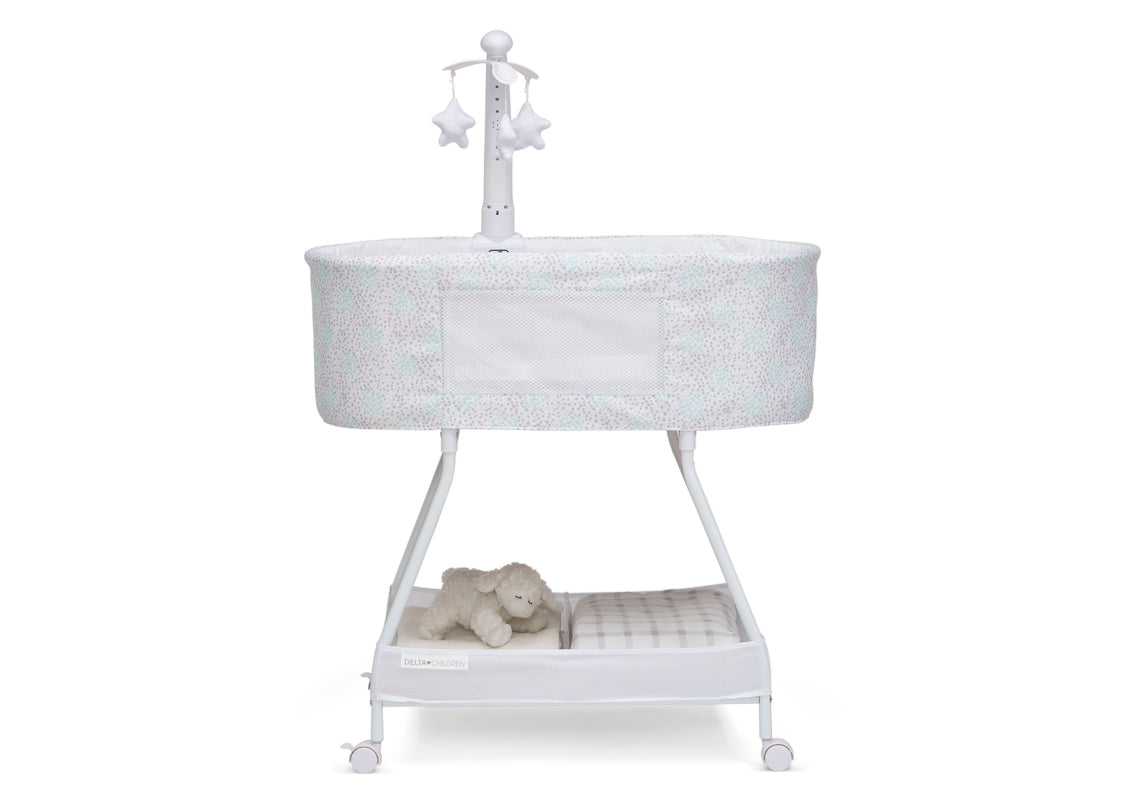 White baby crib with a teddy bear and starry night light on a white background