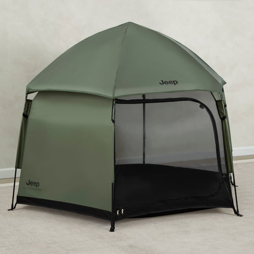 Green Jeep tent with a black floor on a plain background