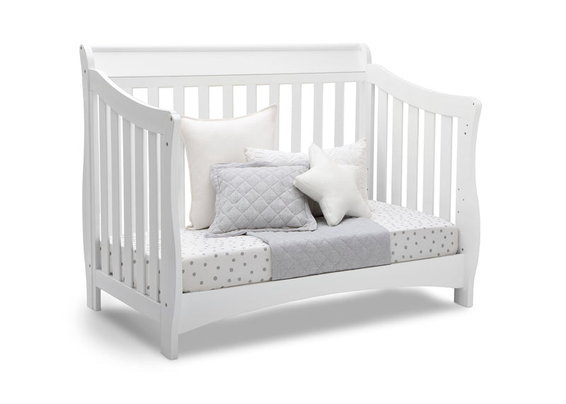 White crib with gray and white bedding on a white background