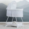 A white Delta Children Deluxe Soothing Dreams Bassinet with mesh sides, an attached electronic pod, and a plush star hanging above the bassinet. 23-Deluxe Soothing Dreams Bassinet