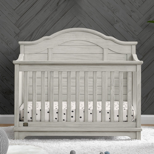 Wooden crib with a dark wooden wall background
