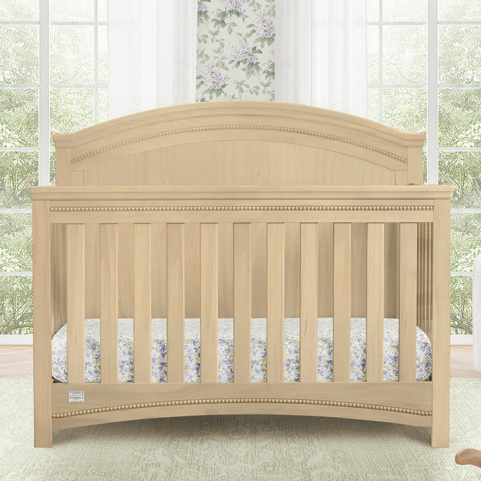 Beige crib in a room with large windows and floral curtains 0-Emma Crib 'N' More