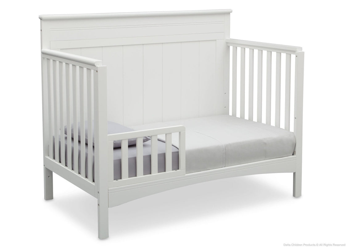 White crib with a mattress on a white background
