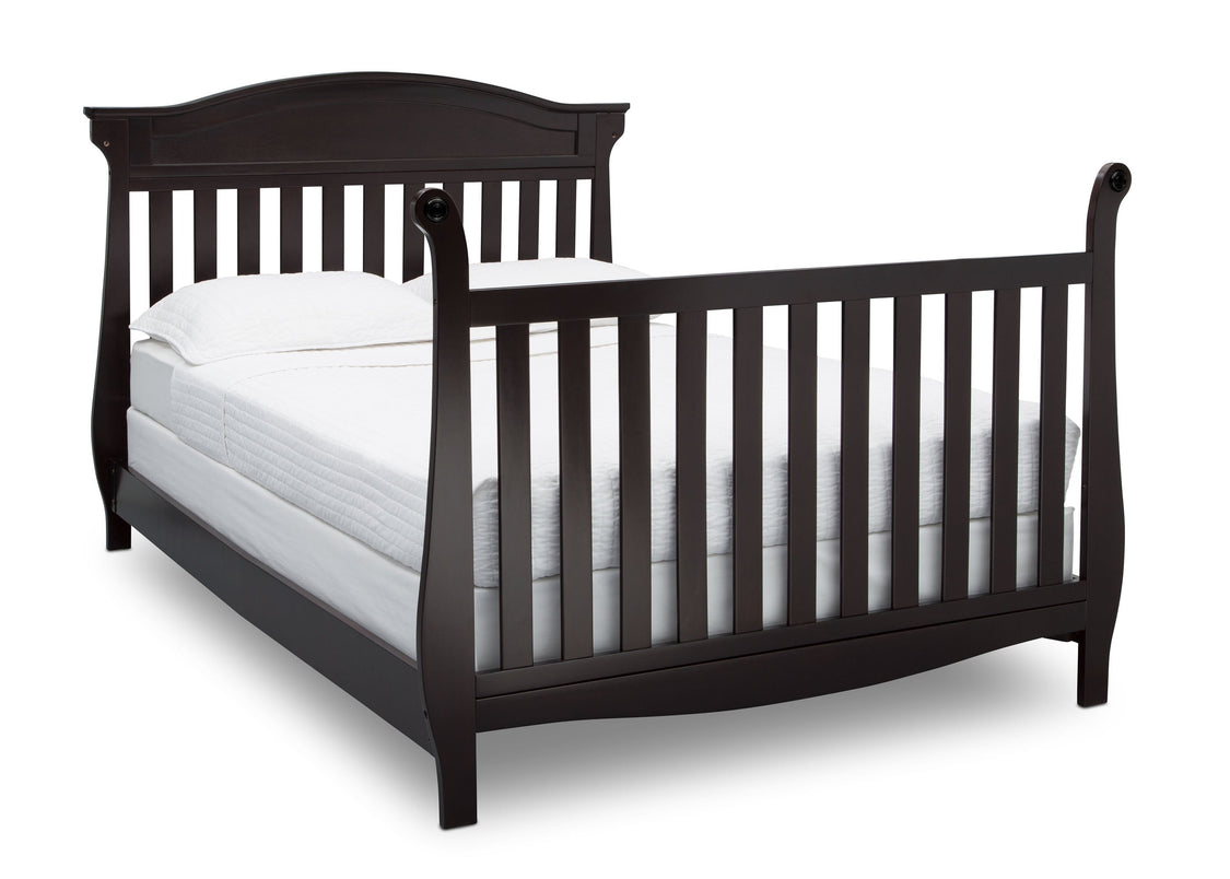 Black crib with white mattress on a white background