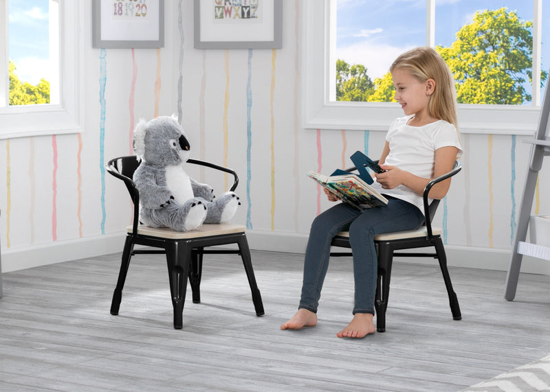 Child reading a book to a plush koala toy on a chair in a bright room with large windows. 35-Bistro 2-Piece Chair Set