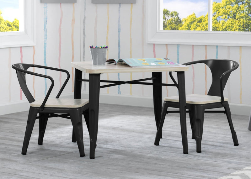 Black metal table and chairs in a room with colorful striped wallpaper.