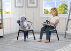 Child sitting on a chair with a toy and reading a book in a room with colorful striped wallpaper. 37-Bistro 2-Piece Chair Set