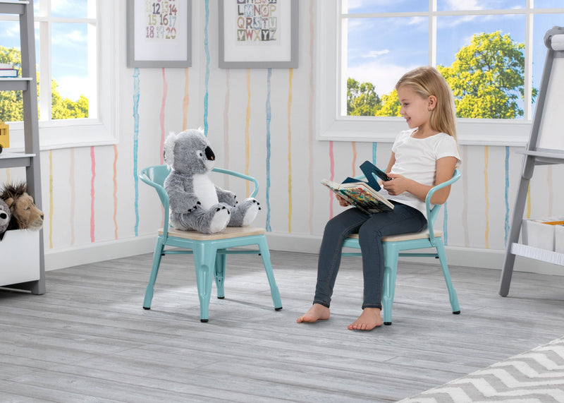 Child sitting on a chair with a toy, reading a book in a bright room with colorful walls.