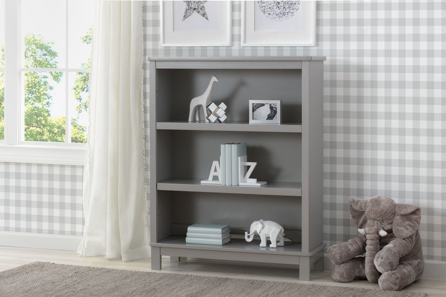 Gray bookshelf with decorative items in a room with checkered wallpaper and a window. 19-Epic Bookcase
