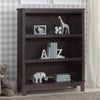 Dark wood bookshelf with decorative items against a checkered wall. 17-Epic Bookcase