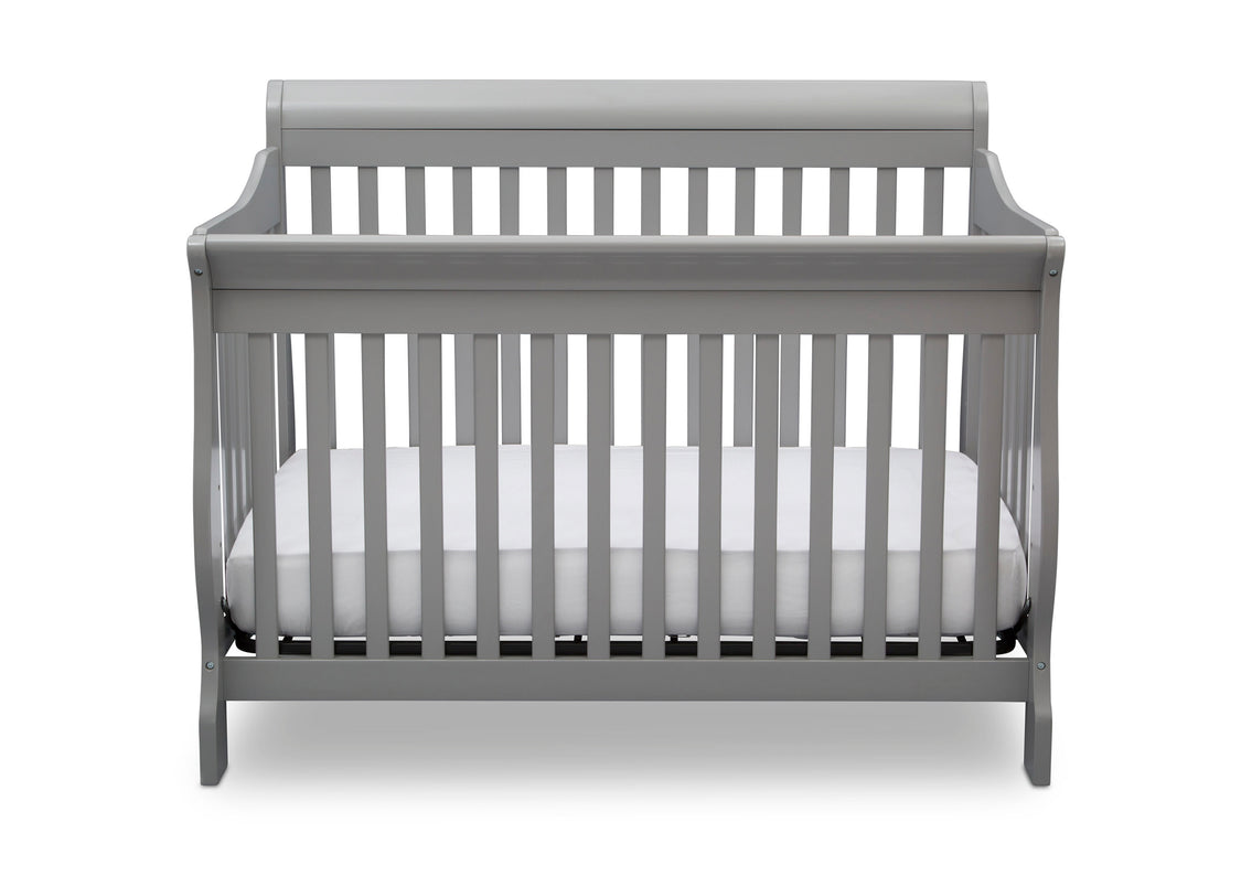 Gray crib with white mattress on a white background