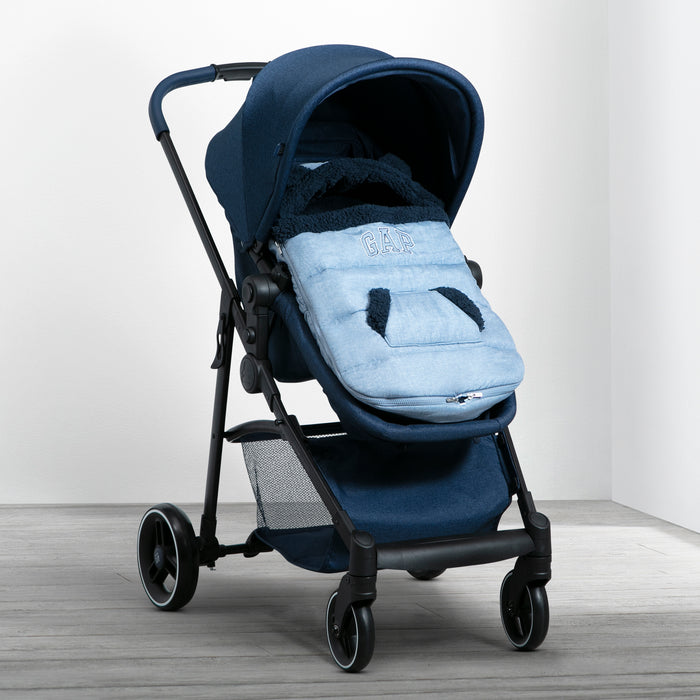 A babyGap infant stroller footmuff in blue and gray, with a hood featuring bear ears, fitted inside a dark blue stroller. 3-babyGap Infant Stroller Footmuff
