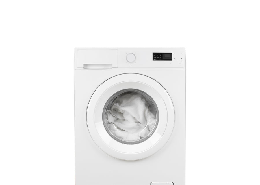 A white front-loading washing machine with a clear circular door showing white laundry inside, photographed against a plain white background. 13-Eco-Cool Cooling Crib Mattress Protector