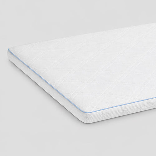 Mattress topper with blue stitching on a light gray background