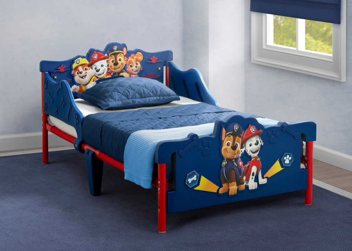 Children's bed with Paw Patrol theme in a room with a window.