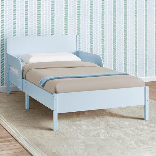 White bed with blue accents against a striped wall