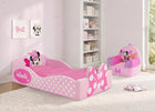 A pink Minnie Mouse children's bed with white polka dots and a matching pink chair in a bright, light pink nursery room. 13-Minnie Mouse Foam Frame Toddler Bed