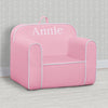 Pink children's chair with 'Annie' printed on it against a gray wall. 5-Personalized Cozee Chair for Kids