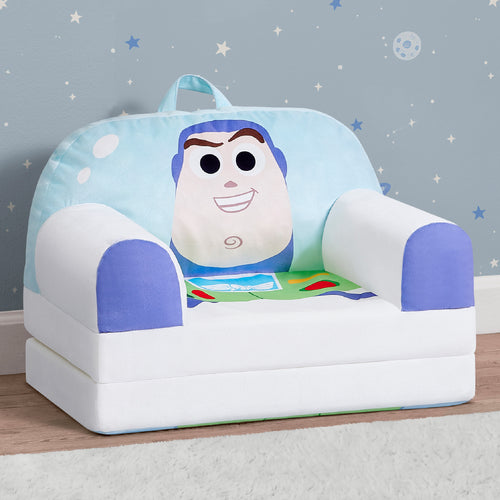 A children's plush armchair styled like Buzz Lightyear, featuring a large Buzz face on the backrest, white body, and blue accents, set against a starry blue wall.