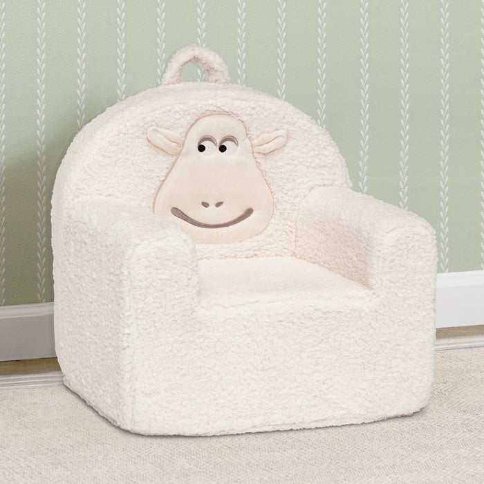 White sheep-shaped bean bag chair against a light green wall with subtle pattern. 0-Counting Sheep Kids Foam Chair