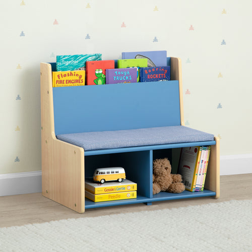 Children's bookshelf with books and toys against a light-colored wall.