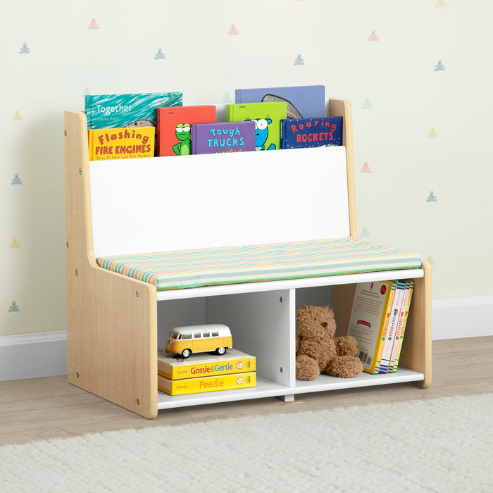 Children's bookshelf with books and toys against a light-colored wall. 2-GapKids Reading Nook with Padded Bench