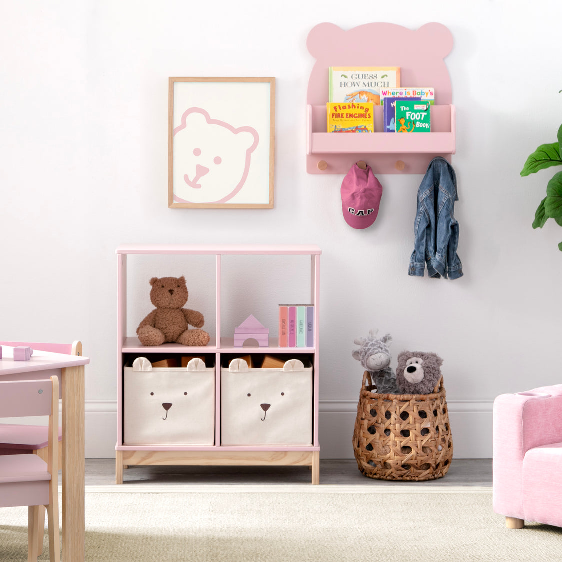 Children's room with pink bookshelf, teddy bear toys, and storage bins.