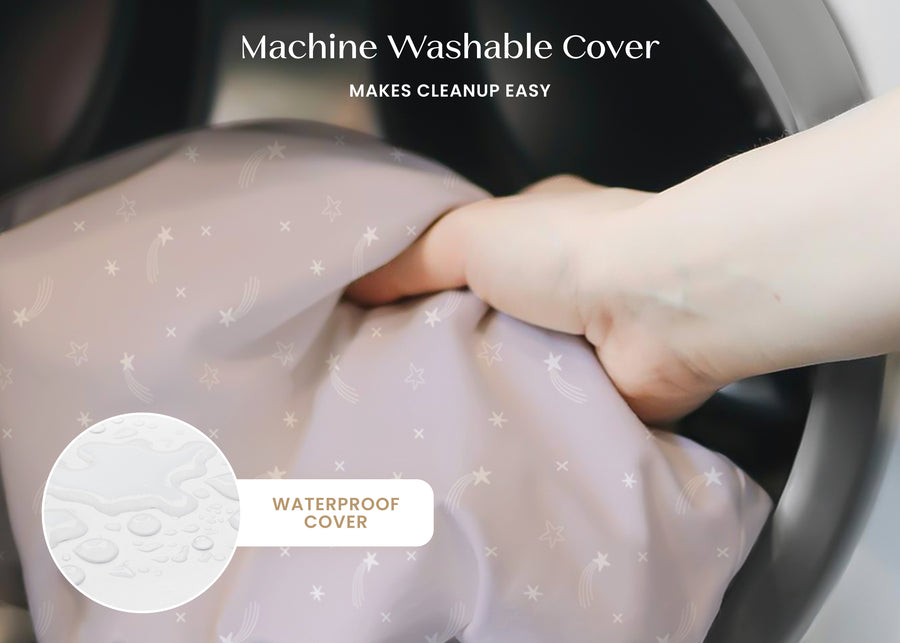 Hand holding a machine washable cover with text indicating it makes cleanup easy and is waterproof. 40-Refresh 2-Stage Crib and Toddler Mattress