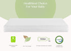 Stack of white baby diapers with green certification logos on a light green background 4-Sweet Beginnings Dual Sided Baby Crib And Toddler Mattress