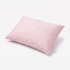 A light pink rectangular pillow with piped edges, shown at an angle on a clean white background. 27-Beautyrest Cooling Toddler Pillow