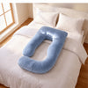 A light blue U-shaped body pillow resting on a neatly made bed with white linens and pillows in a bright bedroom. 48-U-Shaped Pregnancy Pillow with Customizable Head Pillow