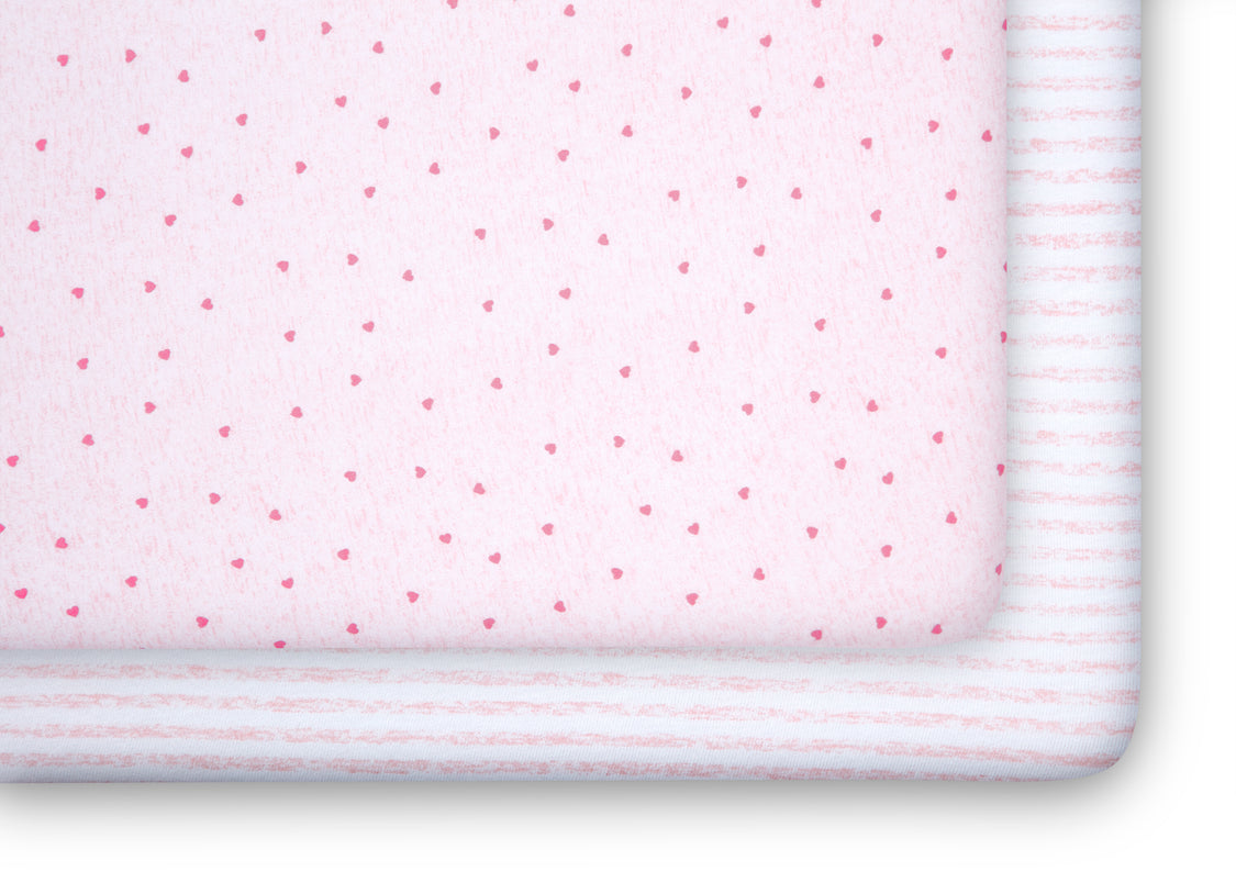 Pink fabric with small red heart patterns and white stripes on a white background