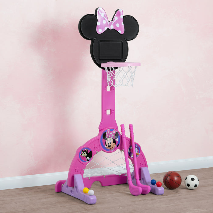 A pink Minnie Mouse themed 4-in-1 sports center with a basketball hoop, soccer/hockey net, and golf game. Includes a basketball, soccer ball, two golf clubs, and four golf balls. 3-Minnie Mouse 4-in-1 Sports Center