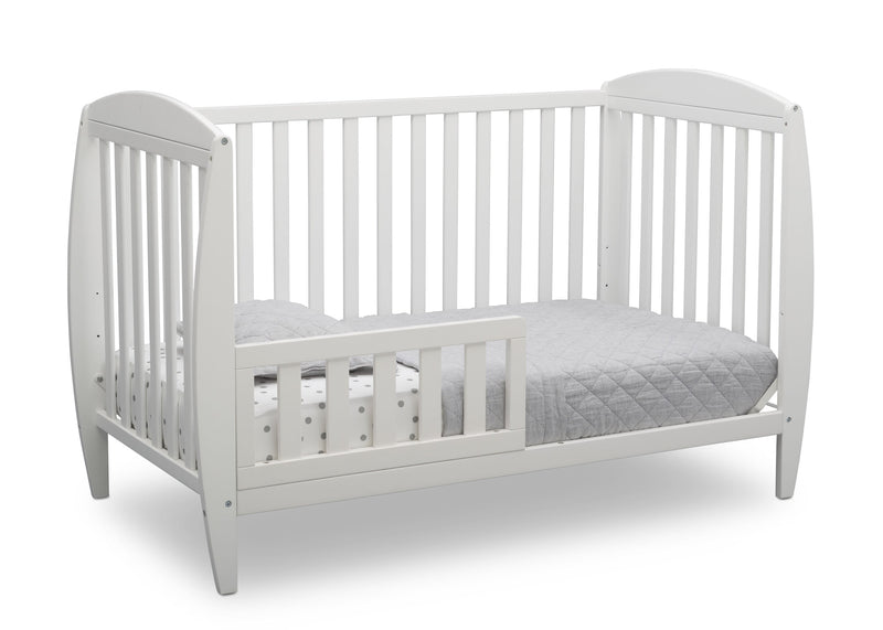 White crib with a gray mattress on a white background