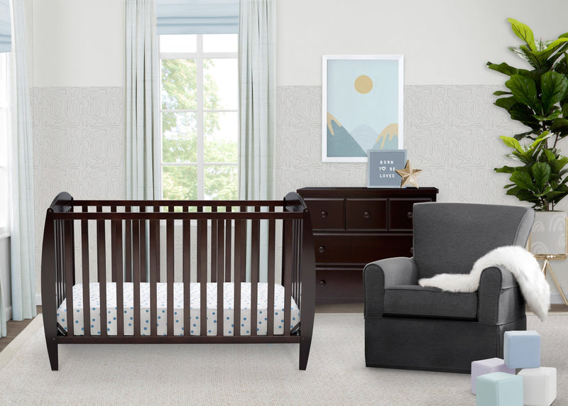 Nursery room with a crib, chair, and dresser.