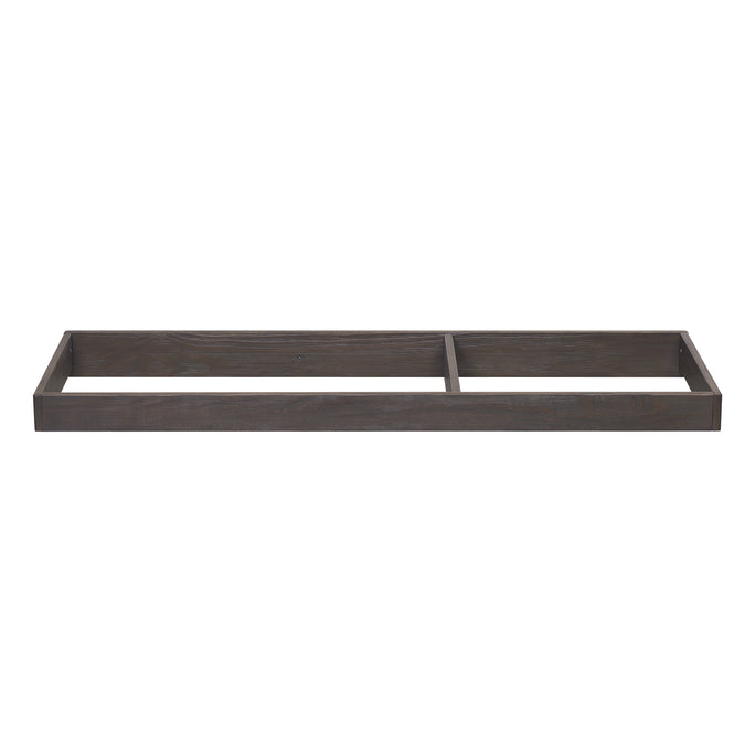 A brown wooden changing top designed to be attached to a dresser, featuring a smaller compartment and a felt bottom. 7-Changing Top (W100920)