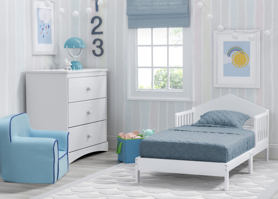 Children's bedroom with white crib, blue chair, and dresser in a bright room. 6-Homestead Toddler Bed