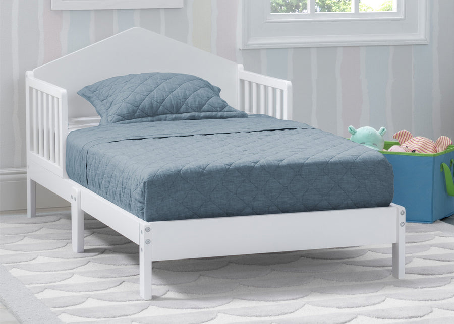 White crib with blue bedding in a room with striped wallpaper 8-Homestead Toddler Bed