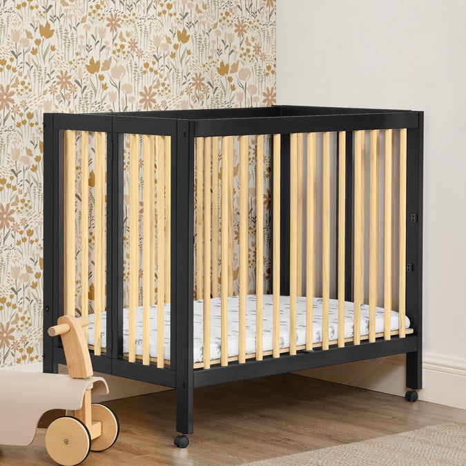 W105550 1482 Mia Portable Mini Crib Black wNatural Lifestyle 111 49-Mia Portable Folding Mini Crib with 1.5-Inch Mattress