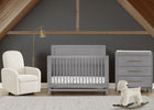 Nursery room with gray crib, white armchair, and rocking sheep toy on a wooden floor. 62-Spencer 6-in-1 Convertible Crib