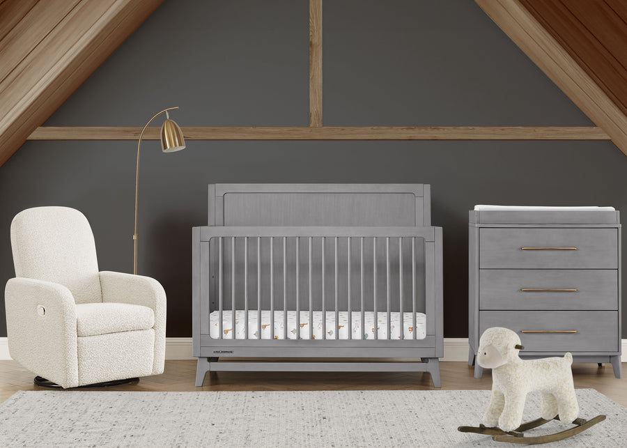 Nursery room with gray crib, white armchair, and rocking sheep toy on a wooden floor. 62-Spencer 6-in-1 Convertible Crib