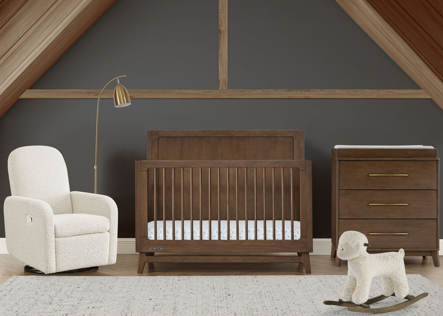 Nursery room with wooden crib, white armchair, and rocking sheep toy. 63-Spencer 6-in-1 Convertible Crib