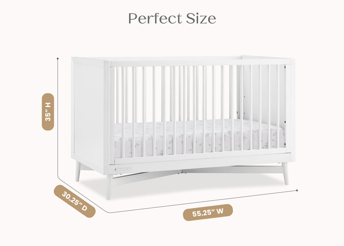 White crib with dimensions labeled on a white background