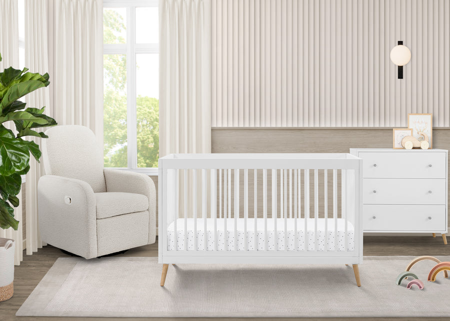 Nursery room with a white crib, armchair, and dresser. 17-Jordan 4-in-1 Convertible Crib