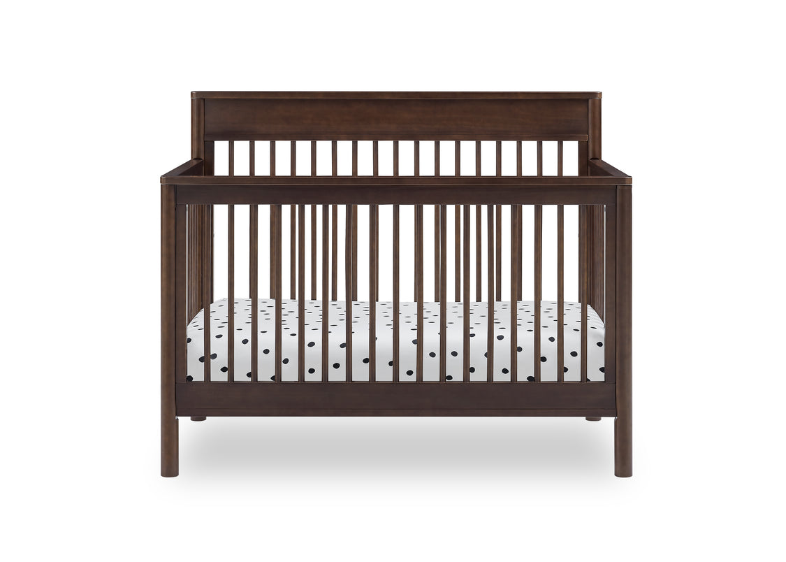 Wooden crib with white mattress on a white background
